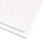 SnuzKot sheets with colorful polka dot pattern on a white background