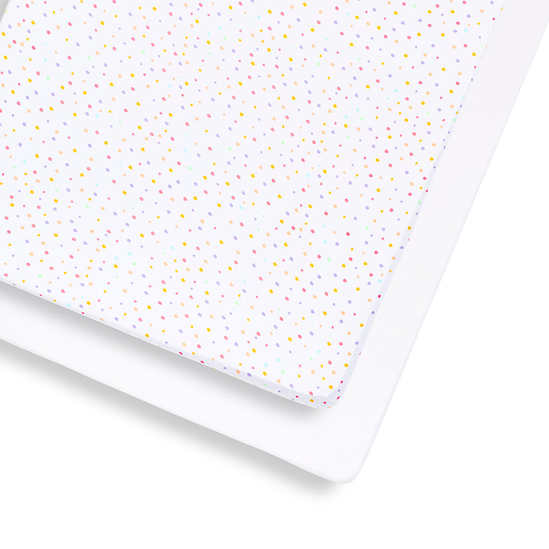 SnuzKot sheets with colorful polka dot pattern on a white background