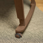 Close-up of a SnüzPod Studio bassinet with wheels