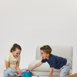 Two children playing with a toy with Rylee Recliner from Cariboo