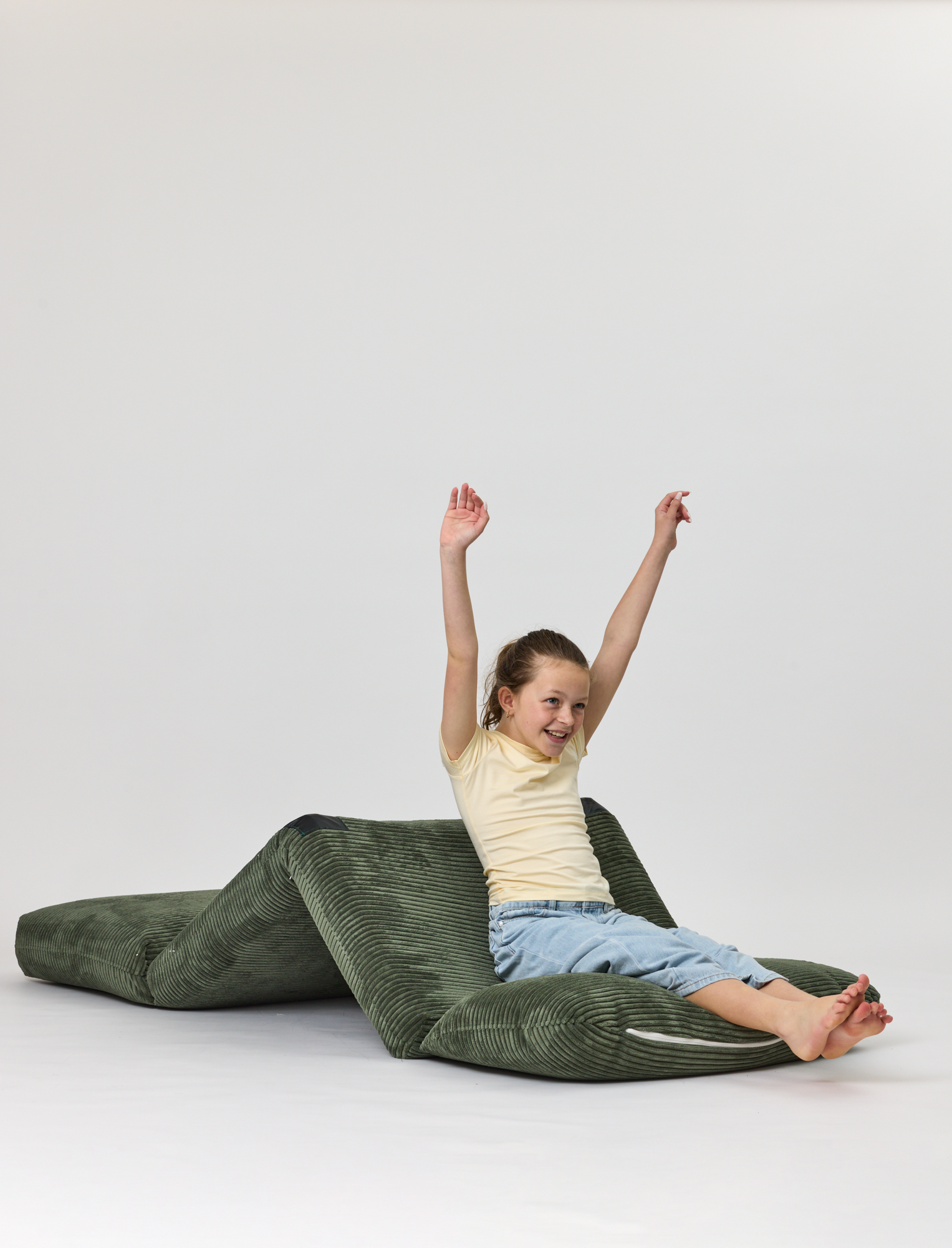 Child sitting on a Forest Rylee Recliner on a white background