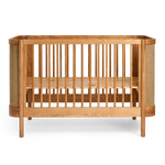 Indi Cot  with woven details on a white background