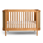 Indi Cot with white mattress on a white background