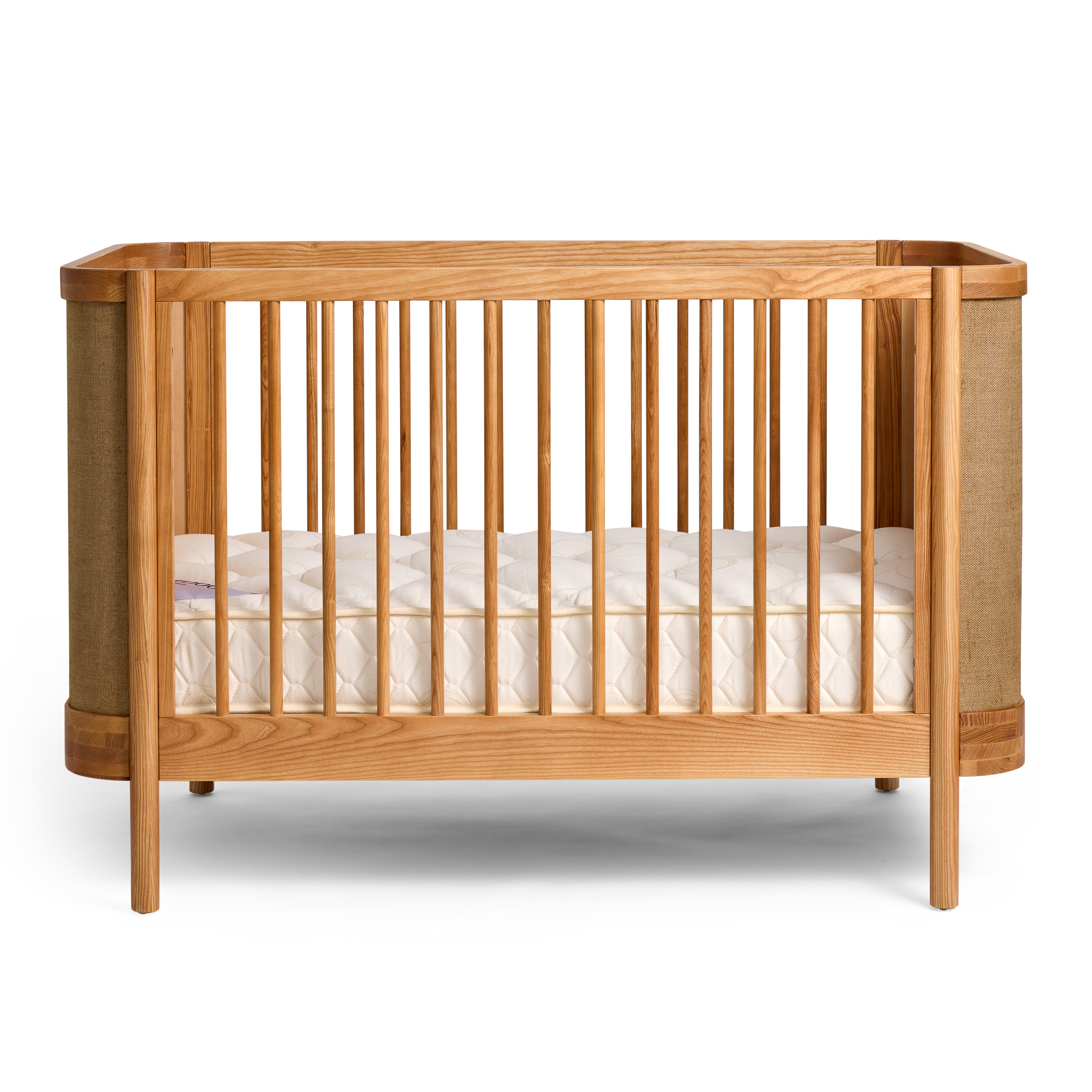 Indi Cot with white mattress on a white background