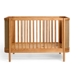 Indi Cot with a natural finish on a white background
