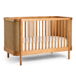 Indi Cot on a side with a white mattress on a white background