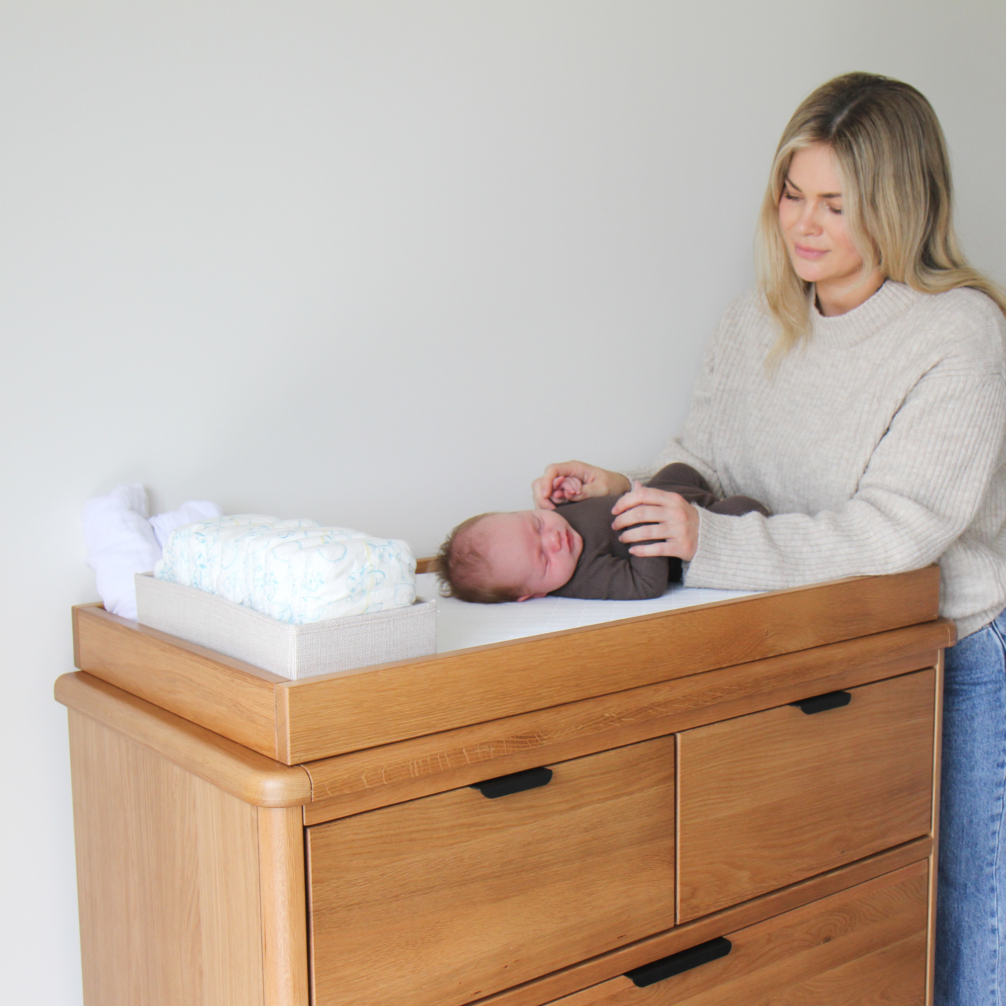 Mother putting baby on the George Change Tray