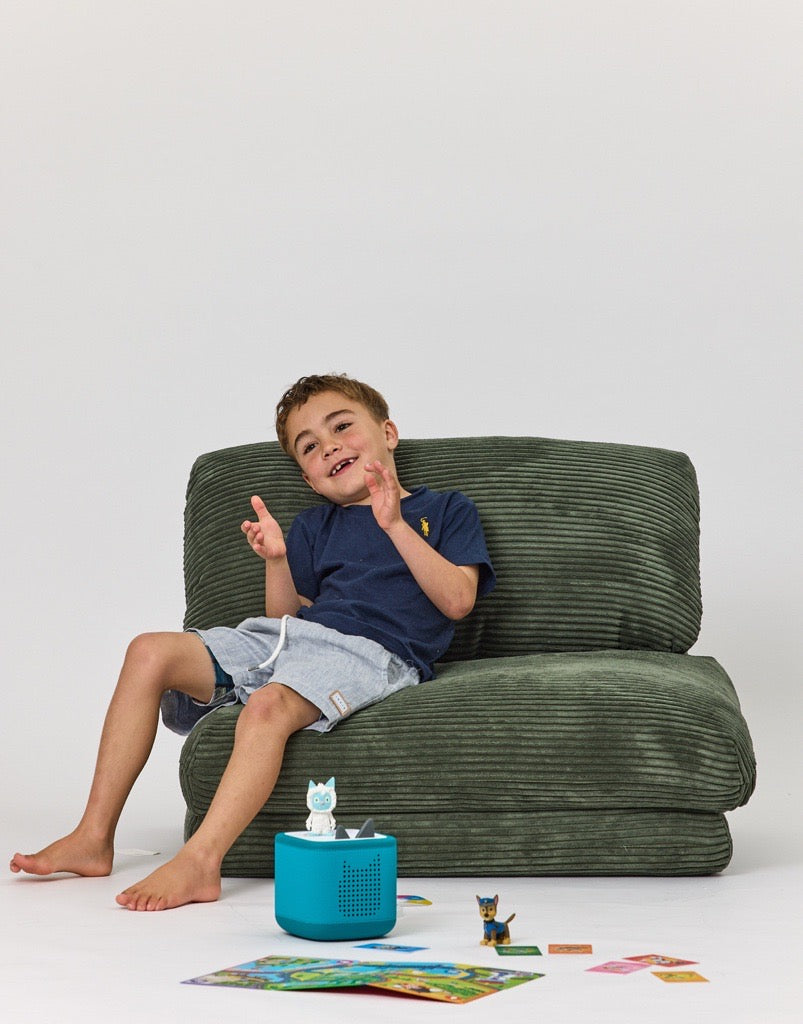 Child sitting on Forest Rylee Recliner on with toys on the floor